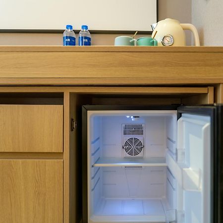 East Sacred Hotel--Very Near Beijing Tiananmen Square ,The Forbidden City,The Temple Of Heaven ,3 Minutes' Walk To Wangfujing Subway ,Located In The Center Of Beijing, Many Shopping Malls Around,Newly Renovated Hotel-Able To Receive Foreign Guests Экстерьер фото A mini-refrigerator in a hotel room
