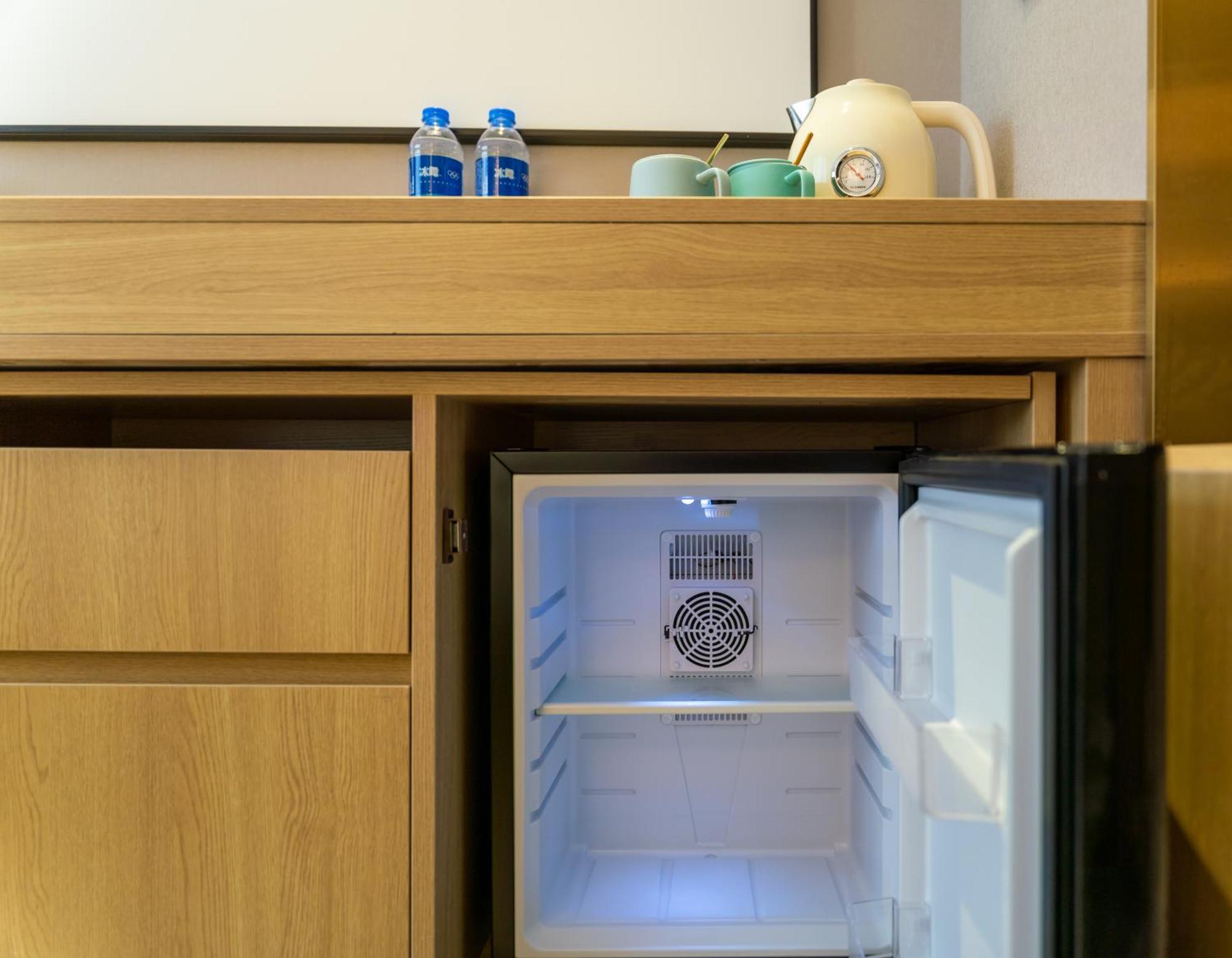 East Sacred Hotel--Very Near Beijing Tiananmen Square ,The Forbidden City,The Temple Of Heaven ,3 Minutes' Walk To Wangfujing Subway ,Located In The Center Of Beijing, Many Shopping Malls Around,Newly Renovated Hotel-Able To Receive Foreign Guests Экстерьер фото A mini-refrigerator in a hotel room